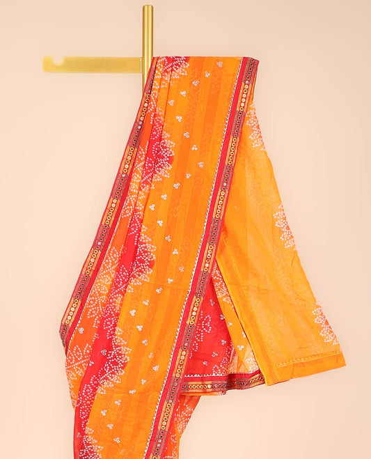 Orange bandhani polka dots printed casual wear saree features leaf creeper design, patchwork border 