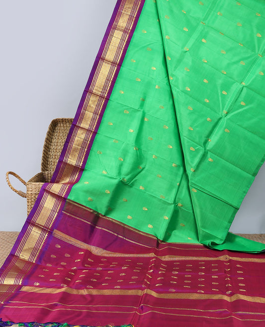 Green kancheepuram silksaree with buttas,contrast zari design pallu & korvai border of thilakam mokku,muthu,banaras,jaal