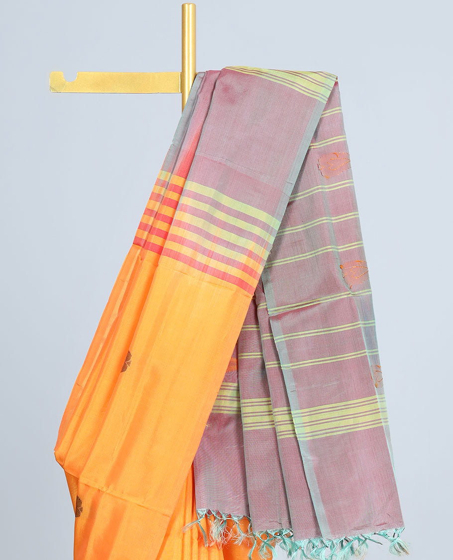 Borderless orange banana pith saree with all-over buttas, contrast pallu of stripes