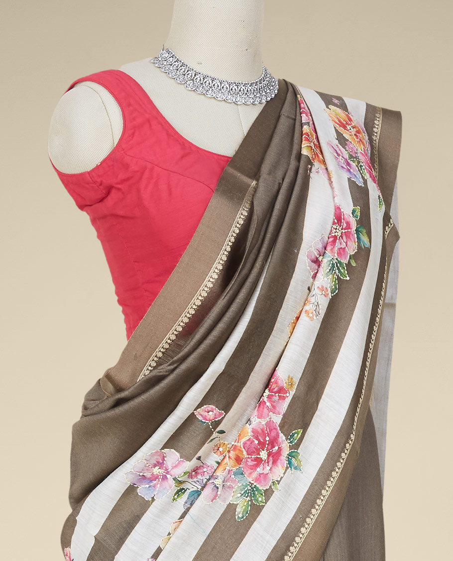 Brown striped digital printed moonga tussar saree with colorful floral motif outlined with thread embroidery,zari border