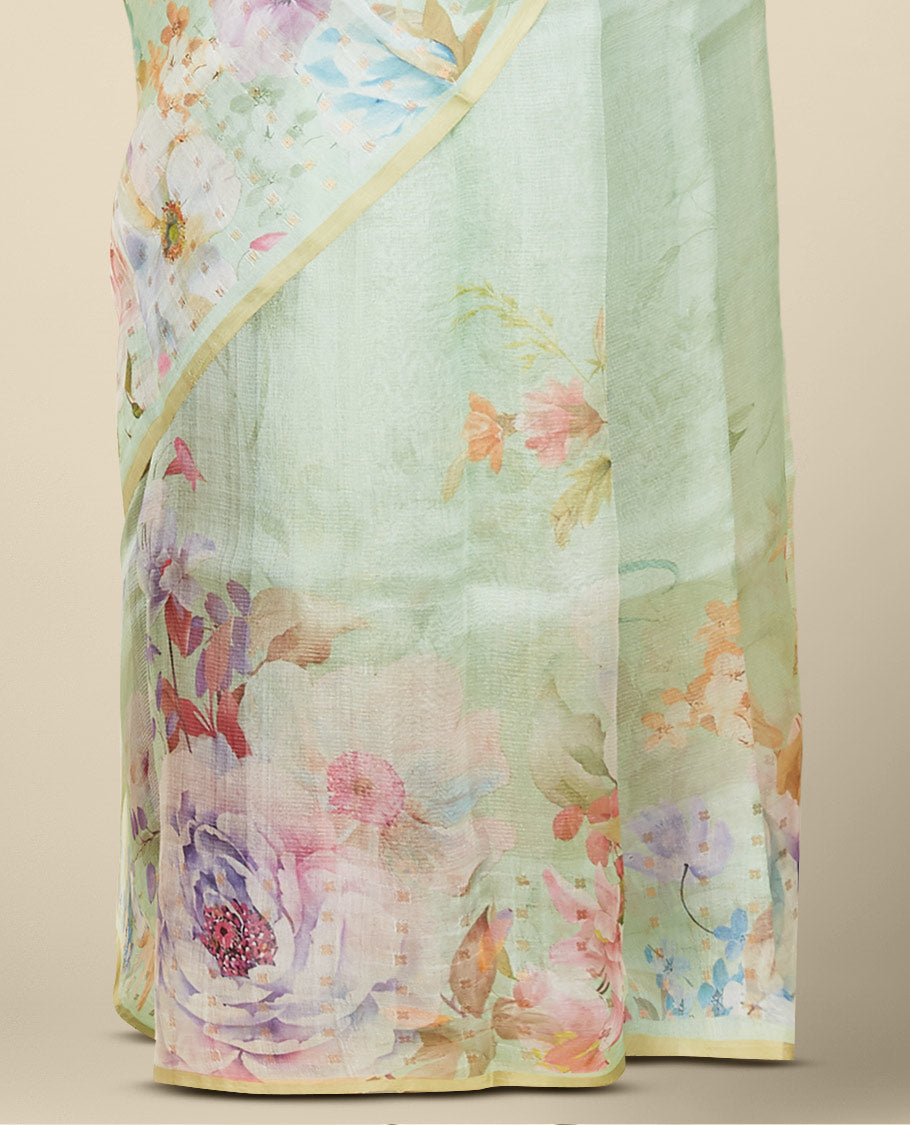 Borderless pastel green organza saree features kaleidoscopic-colored floral motifs print