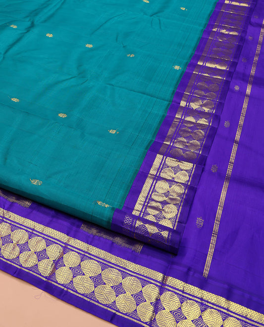 Blue Kanchipuram Silk Saree, Bedecked with Zari Buttas on Its Body, Complemented by a Contrast One-Sided Border of Vanki, Banaras, and Poun Designs, Pallu of Zari Designs, and Comes Without a Blouse