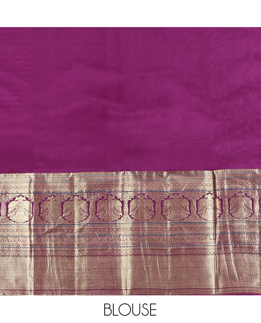 Pink Vasundhara Silk Saree, Elevated with Zari Stripes and Chakram Buttas All Over Its Body, Complemented by a Contrast Border of Rekku, Muthu, Kamalam and Mayil Kann Designs, Grand Geometric Patterned Pallu, and Paired with a Contrast Blouse
