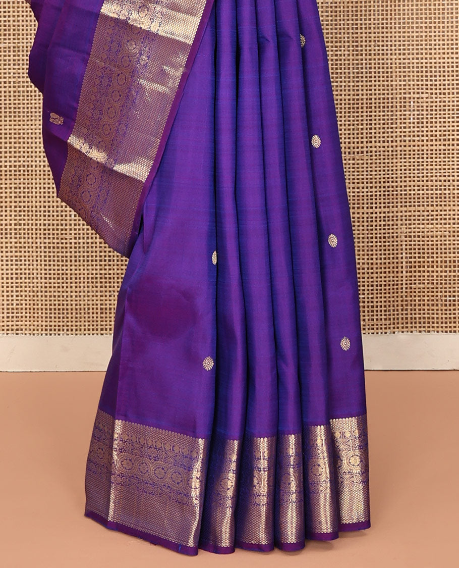Violet Kanchipuram Silk Saree, Ornamented with Zari Buttas All Over Its Body, Highlighted by Zari Border of Thilakam, Mayil Kann, Poun, Jada Nagam, Dhavana Kodi, and Mayil Kann Designs, Pallu of Jaal Designs, and Paired with a Matching Blouse