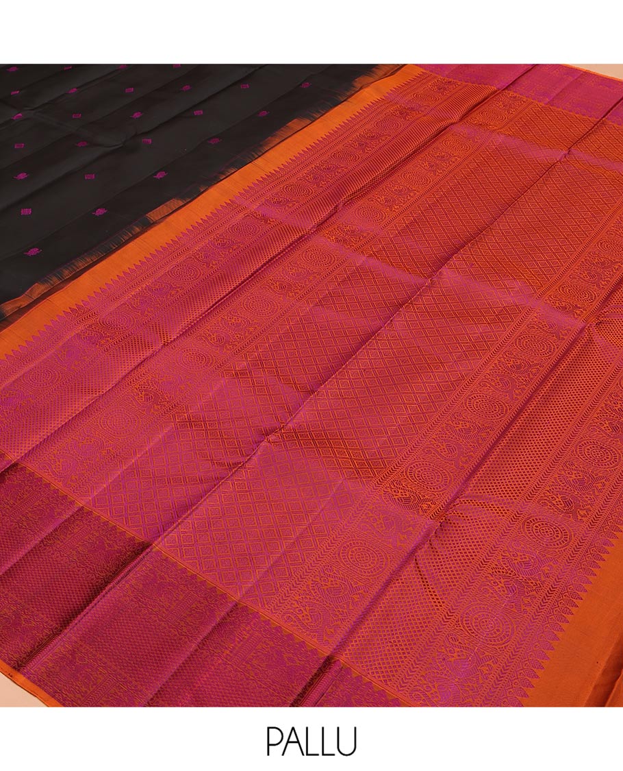 Black Kanchipuram Silk Saree, Masterfully Woven with Mayil-Chakram Buttas All Over Its Body, Complemented by a Contrast Border of Thilakam Mokku, Iruthalai Pakshi, and Kuyil Kann Designs, and Pallu of Jaal Designs, and Paired with a Contrast Blouse