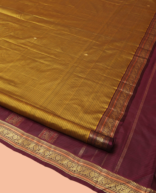 Mustard Kanchipuram Silk Saree Adorned with Vazhaipoo Stripes and Zari Buttas, Complemented by a Contrast Border of Thazampoo Rekku, Greek Key, and Kodi Mayil Designs, Zari-Woven Pallu, and Paired with a Contrast Blouse