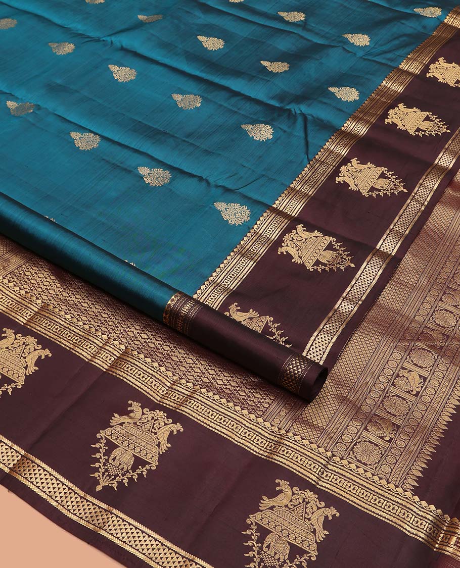 Blue Vasundhara Silk Saree, Elegantly Framed with Zari Buttas All Over Its Body, Complemented by a Contrast Border of Thilakam Mokku, Neli, Kathir, and Ara Maadam Designs, Grand Pallu, and Paired with a Contrast Blouse