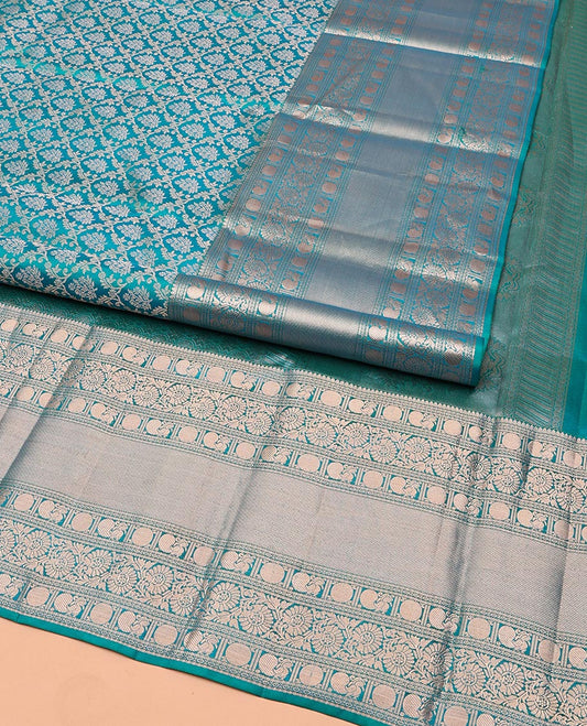 Rama Blue Kanchipuram Wedding Silk Saree, Mesmerized with Jaal Jacquard on Its Body, Highlighted by a Zari Border of Thilakam Mokku, Poun, Mayil, and Kodi Visiry Designs, Grand Pallu Steeped with Chakram Designs, and Paired with a Matching Blouse