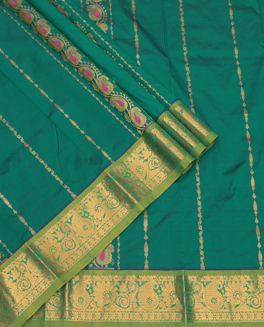 Green Art Silk Pavadai Material Set, Decorated with Zari Designs on Its Skirt, Complemented by a Contrast Paisley Zari Border, and a Matching Blouse