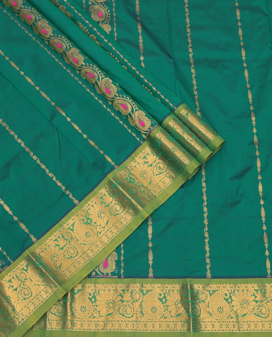 Green Art Silk Pavadai Material Set, Decorated with Zari Designs on Its Skirt, Complemented by a Contrast Paisley Zari Border, and a Matching Blouse