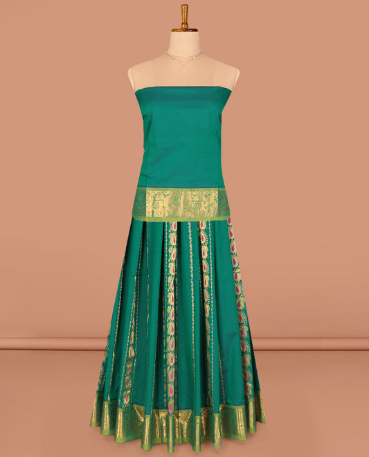 Green Art Silk Pavadai Material Set, Decorated with Zari Designs on Its Skirt, Complemented by a Contrast Paisley Zari Border, and a Matching Blouse