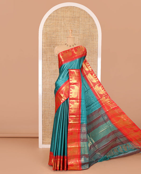 Peacock green zari checked semi-taffeta saree, contrast satin temple border of elephant motifs, striped pallu, and a contrast striped blouse