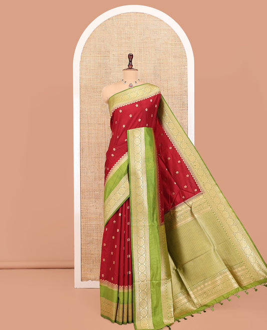 Maroon Dupion Silk Saree, Accentuated with Buttas All Over Its Body, Complemented by Contrast Traditional Border of Paisleys and Chakram Designs, Intricately Designed Pallu, and Paired with a Contrast Blouse