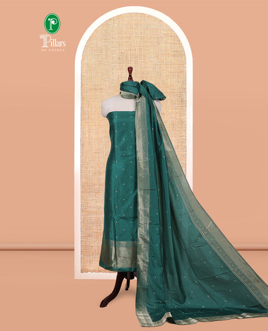 Green Semi-Silk Material Churidar Features Zari Buttas Woven Top, a Santoon Bottom, and Zari Design Dupatta