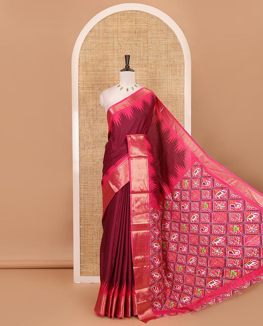 Maroon plain dola-tussar saree, contrast temple zari border, patola animal motifs enclosed jaal printed pallu & patola printed blouse