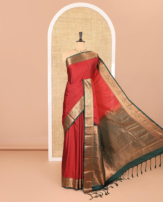 Maroon plain luxury soft silk saree, contrast traditional temple zari border of elephant motifs, geometric zari pallu, and a contrast jacquard blouse