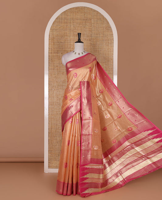 Peach antique buttas tissue silk saree, contrast satin zari border of half-moon motifs, pallu of temple design pallu, and contrast butta blouse