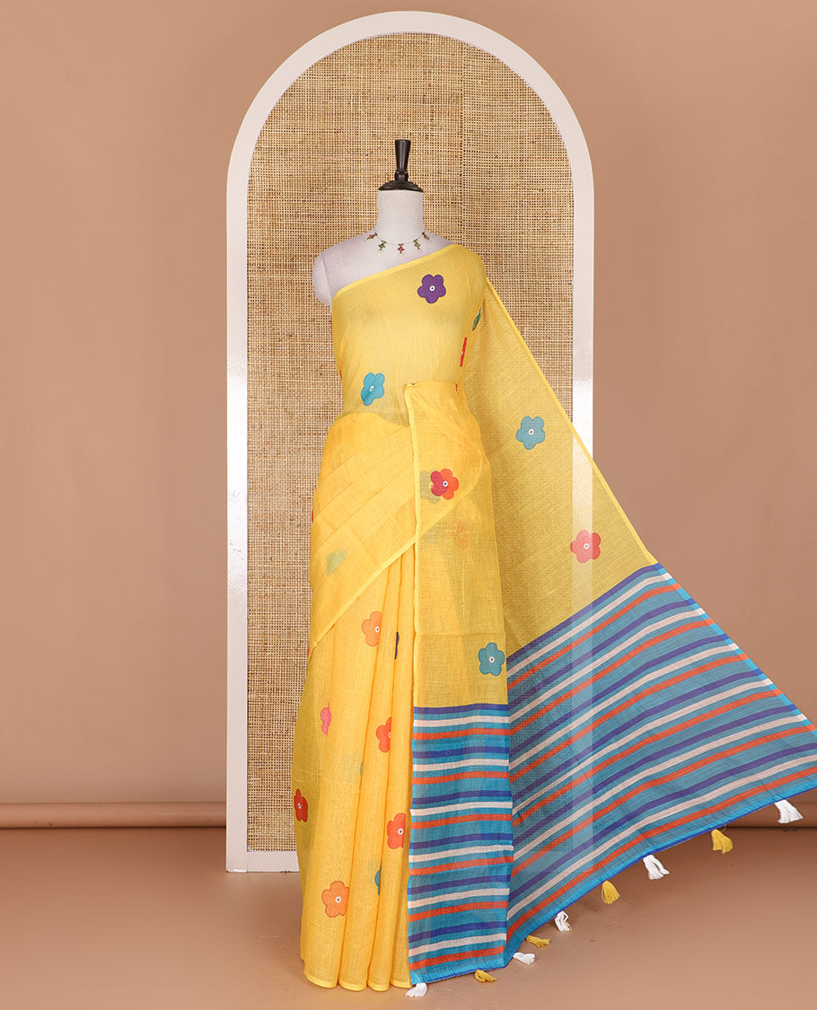 Borderless Yellow colorful five-petal flower motifs printed linen cotton saree, multi-color striped pallu, and contrast printed blouse