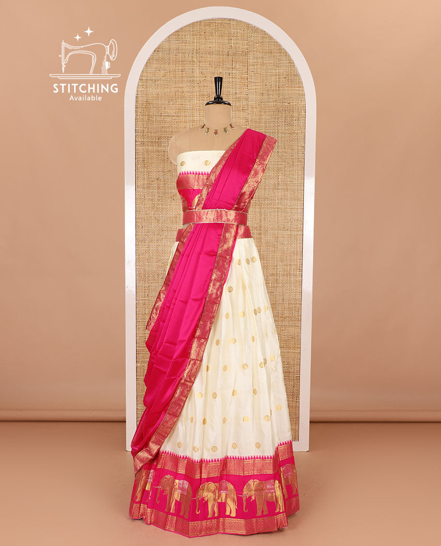 Cream-pink half-saree, zari buttas with contrast traditional zari elephant motifs bordered skirt, matching blouse and a contrast zari border dhavani