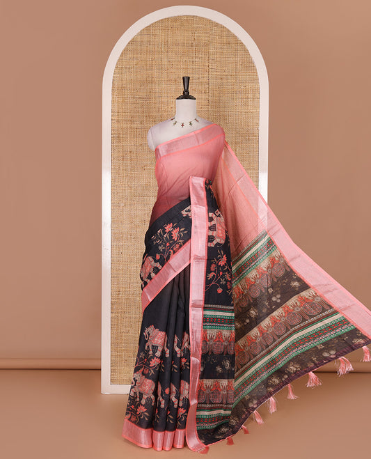 Black 2D style dyed and elephant-floral theme printed linen cotton saree, contrast zari bavanji border, intricately printed pallu, and contrast printed blouse