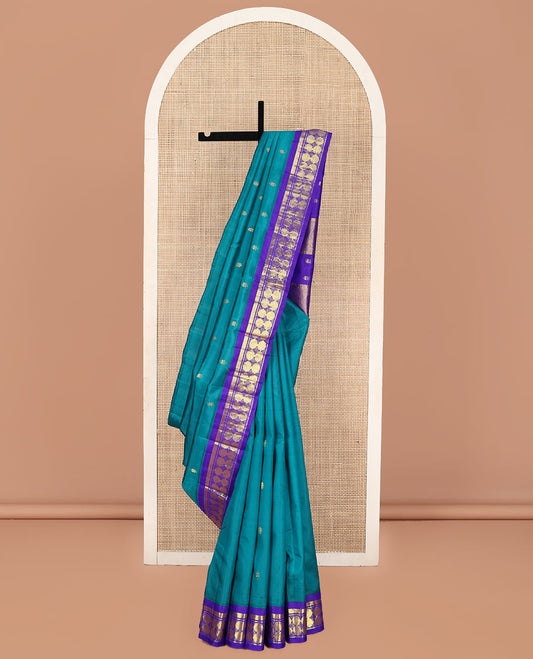 Blue Kanchipuram Silk Saree, Bedecked with Zari Buttas on Its Body, Complemented by a Contrast One-Sided Border of Vanki, Banaras, and Poun Designs, Pallu of Zari Designs, and Comes Without a Blouse