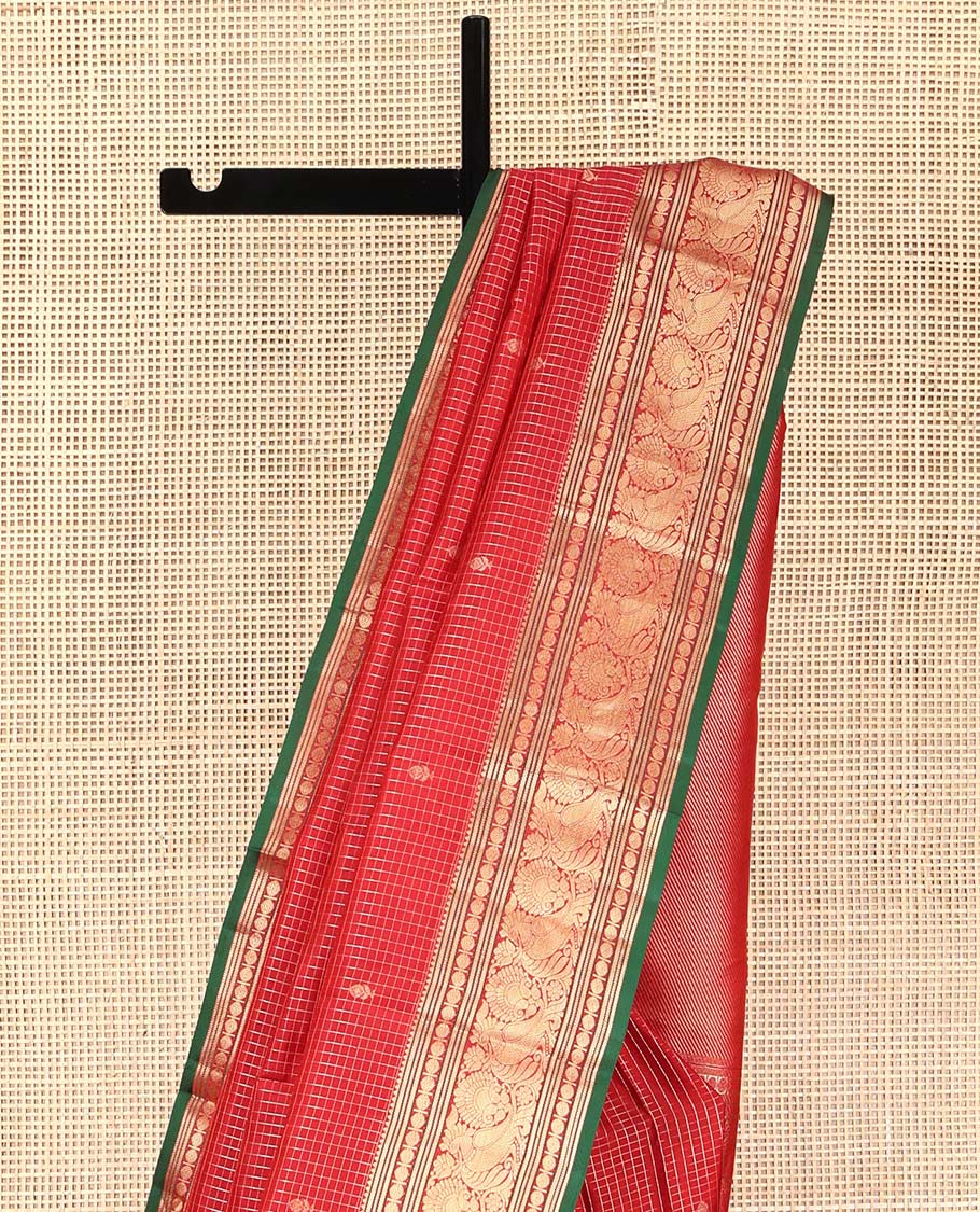 Red Kanchipuram Silk Saree, Richly Detailed with Zari Butta Enclosed Checks on Its Body, Highlighted by Zari Border of Rekku, Poun, Banaras, and Mayil Kann Designs, Diagonally Striped Pallu, and Paired with a Contrast Blouse