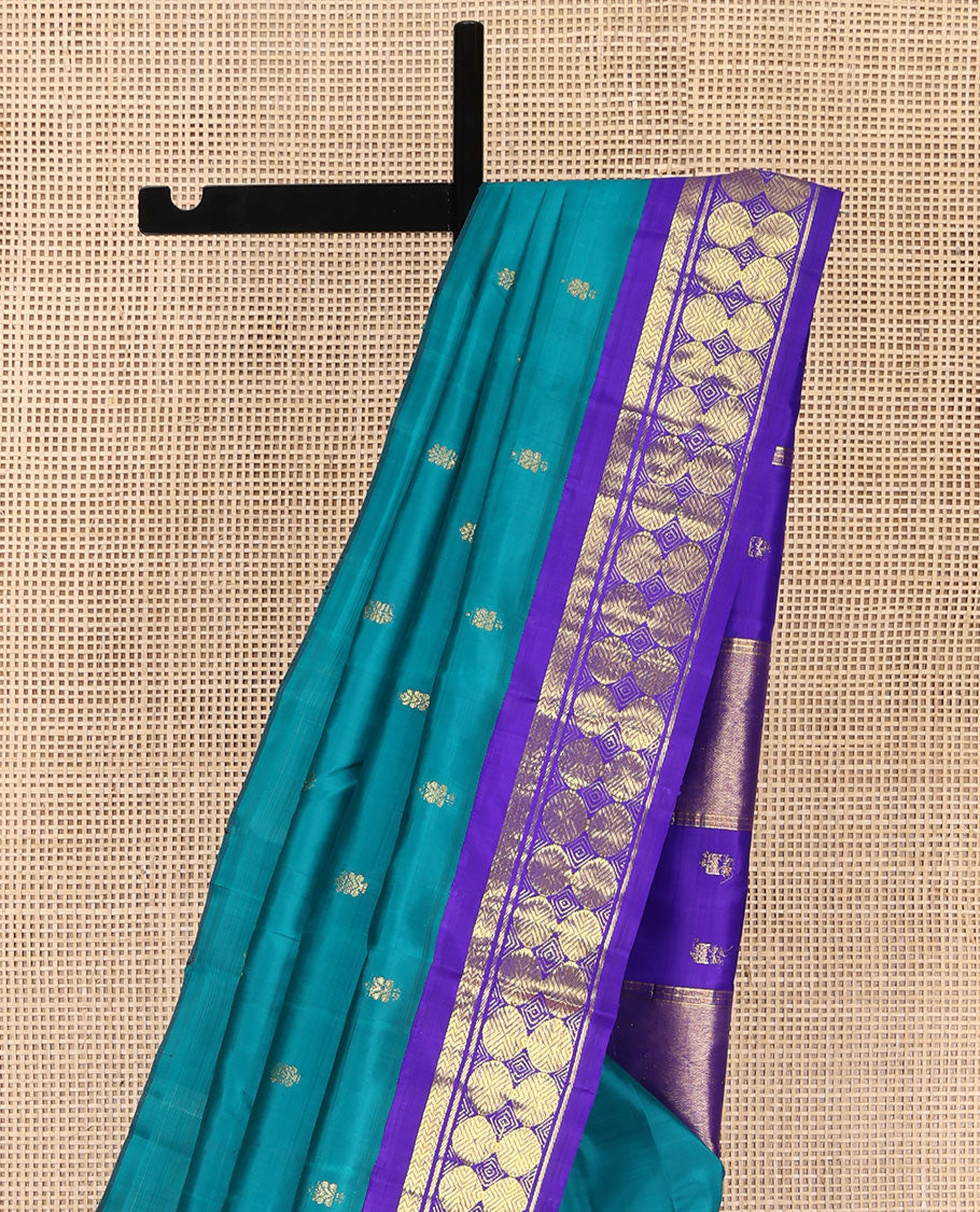 Blue Kanchipuram Silk Saree, Bedecked with Zari Buttas on Its Body, Complemented by a Contrast One-Sided Border of Vanki, Banaras, and Poun Designs, Pallu of Zari Designs, and Comes Without a Blouse