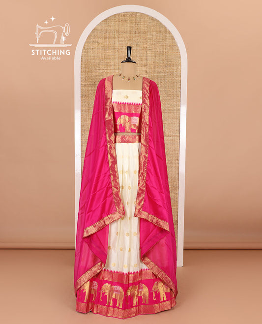 Cream-pink half-saree, zari buttas with contrast traditional zari elephant motifs bordered skirt, matching blouse and a contrast zari border dhavani