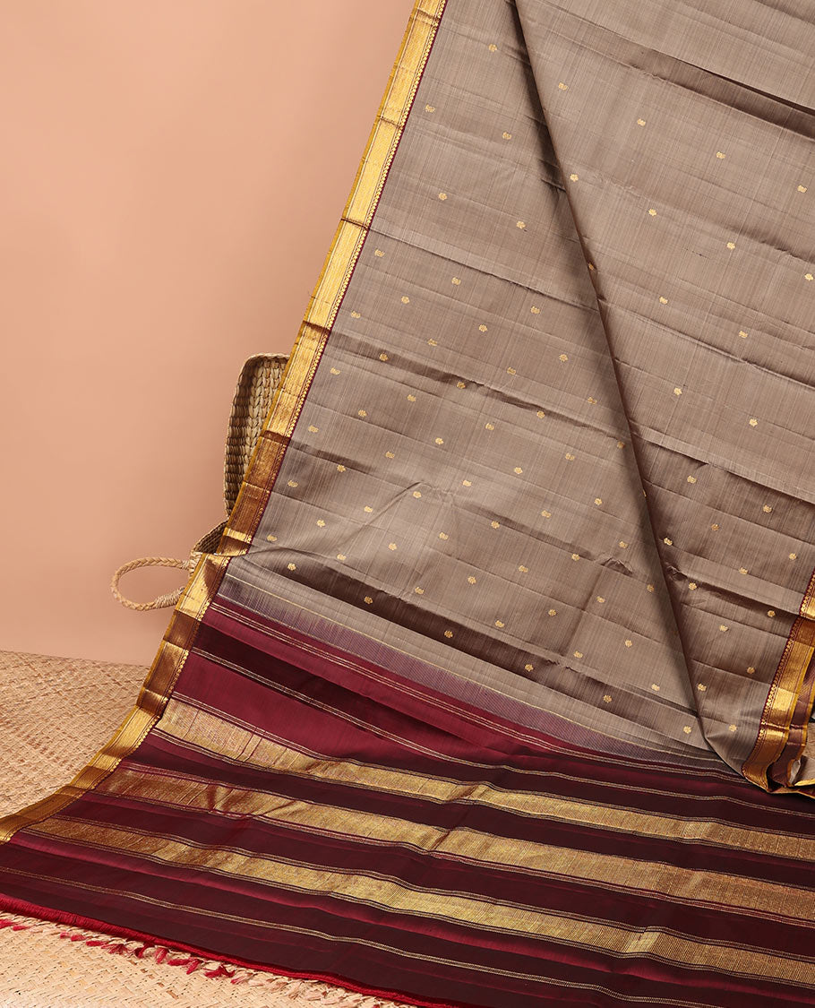Grey floral buttas kancheepuram silk saree with contrast border of thilakam mokku, muthu, banaras design & zari design pallu