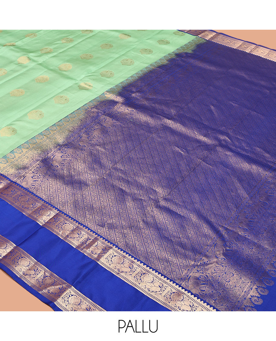 Pastel Sea Green Vasundhara Silk Saree, Ornamented with Zari Buttas All Over Its Body, Complemented by a Contrast Rettai Pettu Border of Rekku, Ara Maadam, and Mayil Designs, Grand Pallu, and Paired with a Contrast Blouse