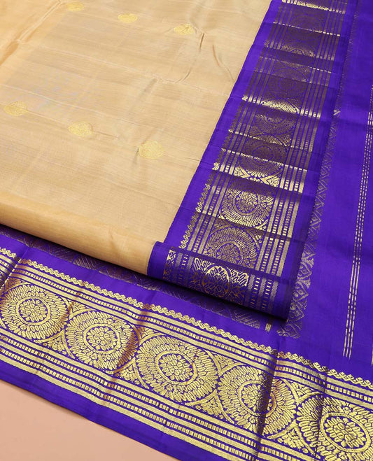 Sandal Kanchipuram Silk Saree, Sparsely Woven with Zari Buttas on Its Body, Complemented by a Contrast One-Sided Korvai Border of Salngai, Banaras, Muthu, and Chakram Designs, Pallu Steeped with Chakram Designs, and Comes Without a Blouse