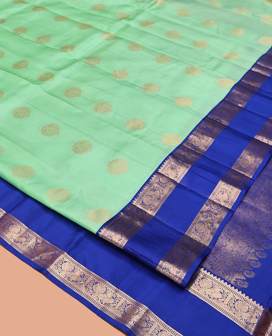 Pastel Sea Green Vasundhara Silk Saree, Ornamented with Zari Buttas All Over Its Body, Complemented by a Contrast Rettai Pettu Border of Rekku, Ara Maadam, and Mayil Designs, Grand Pallu, and Paired with a Contrast Blouse