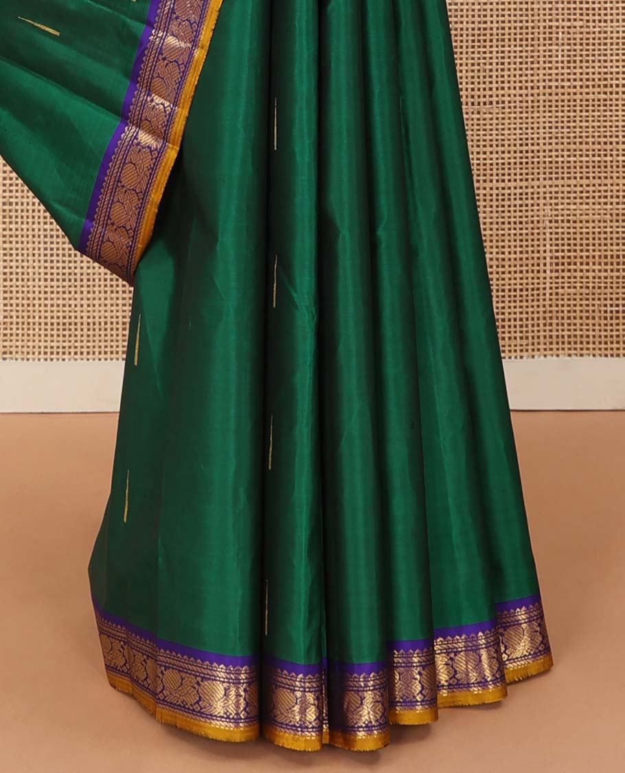 Green malli mokku buttas Kanchipuram silk saree, contrast border of rekku, muthu, banaras, and mayil designs, and traditional design pallu