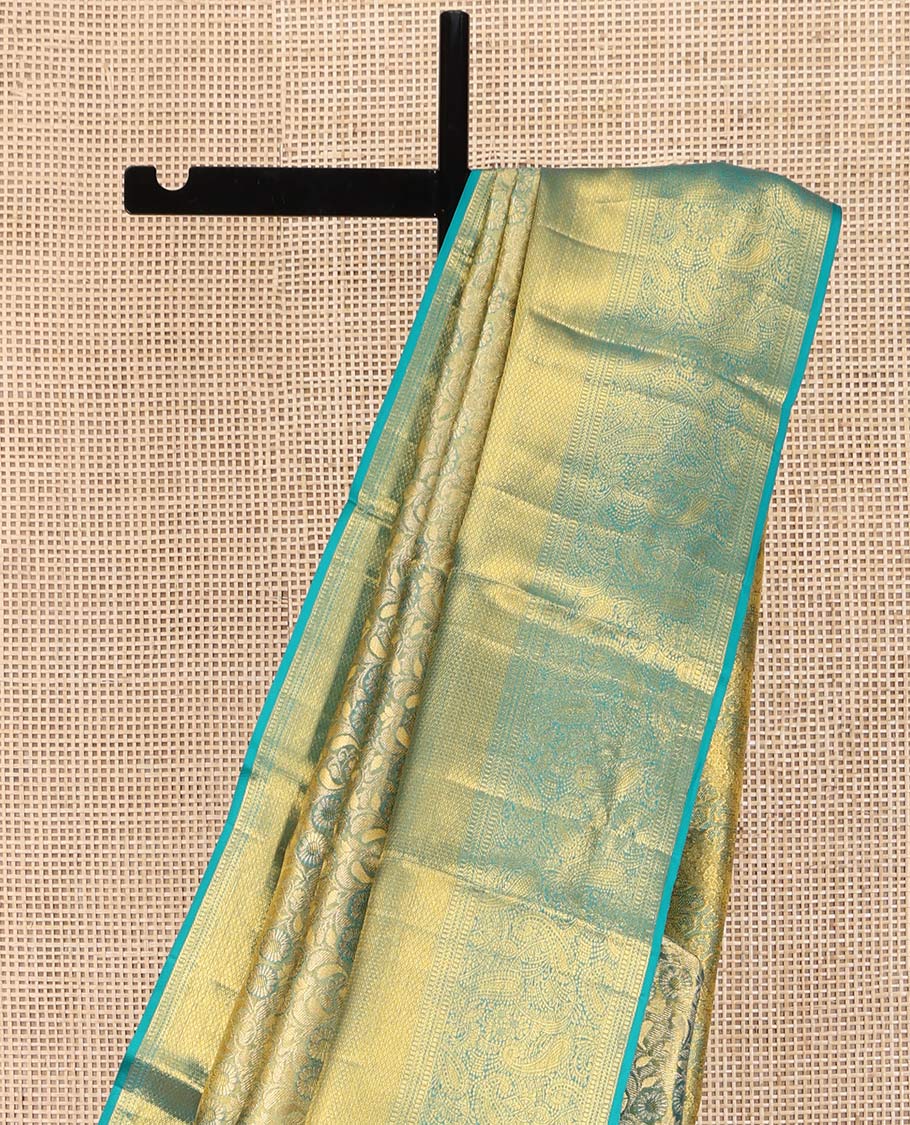 Blue Kanchipuram Silk Saree, Elegantly Highlighted with Zari Jacquard Design All Over Its Body, Highlighted by a Zari Border of Thilakam Mokku, Muthu, Mayil Kann, and Manga Designs, and Pallu of Mughal-Style Designs, and Paired with a Matching Blouse