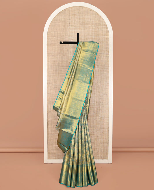 Blue Kanchipuram Silk Saree, Elegantly Highlighted with Zari Jacquard Design All Over Its Body, Highlighted by a Zari Border of Thilakam Mokku, Muthu, Mayil Kann, and Manga Designs, and Pallu of Mughal-Style Designs, and Paired with a Matching Blouse