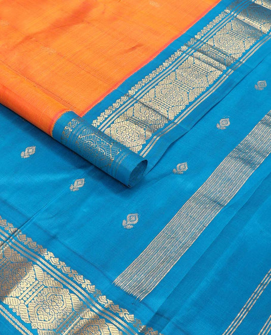 Orange buttas kancheepuram silk saree with contrast korvai border of thilakam mokku, banaras design & floral buttas pallu