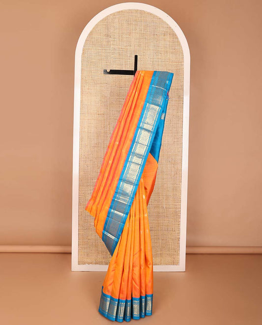 Orange buttas kancheepuram silk saree with contrast korvai border of thilakam mokku, banaras design & floral buttas pallu