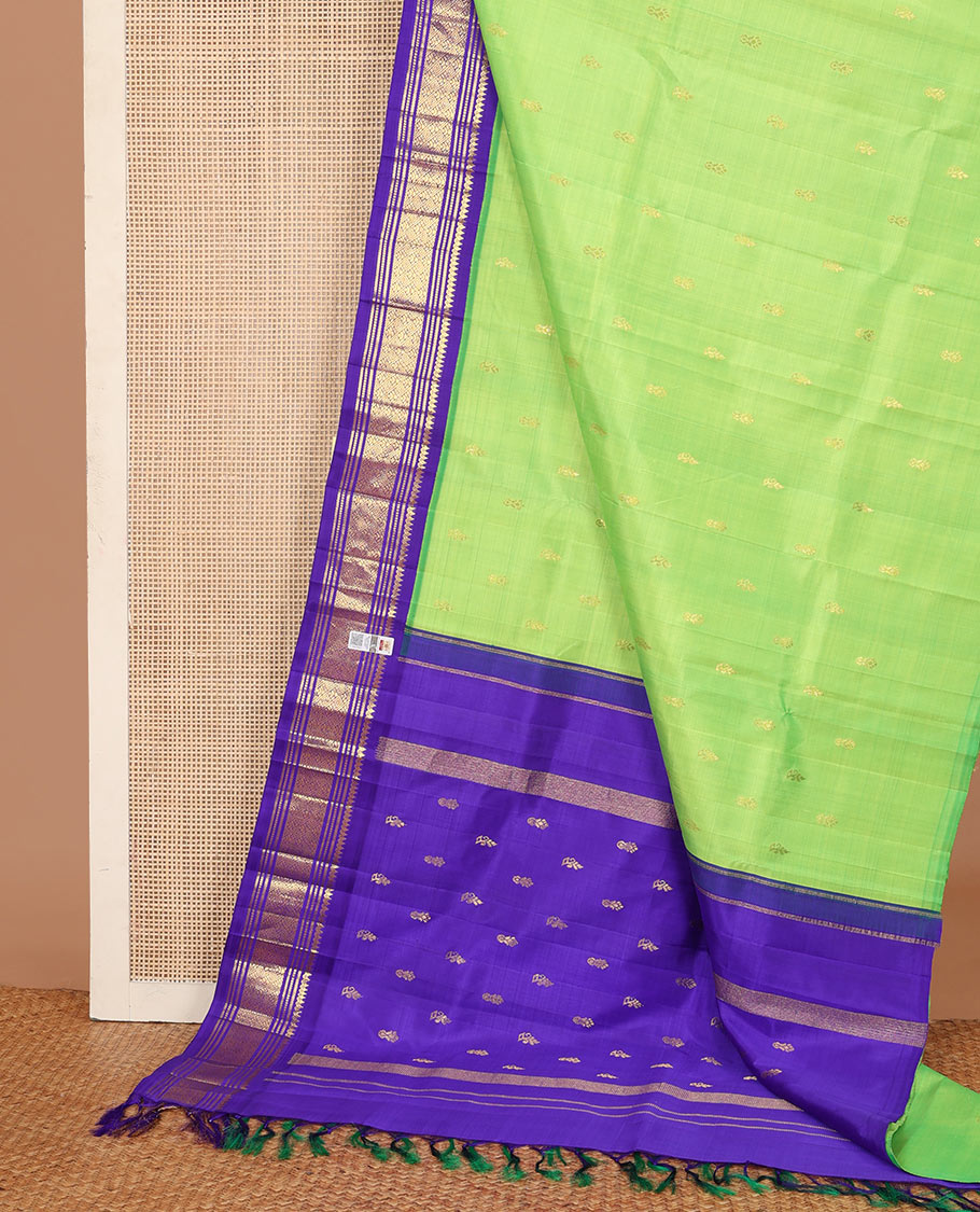 Green zari buttas Kanchipuram silk saree, contrast one-sided korvai zari border of thilakam mokku, banaras, muthu, and jaal, and zari design pallu