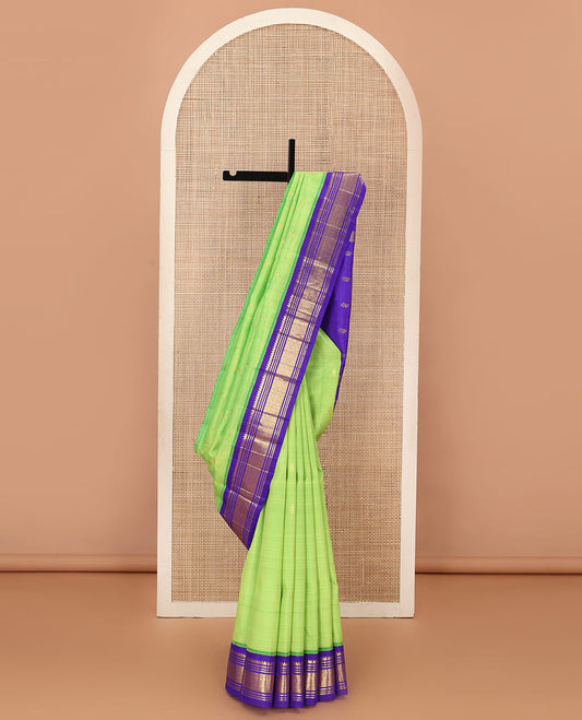 Green zari buttas Kanchipuram silk saree, contrast one-sided korvai zari border of thilakam mokku, banaras, muthu, and jaal, and zari design pallu