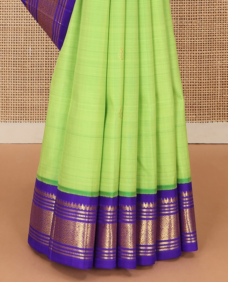 Green zari buttas Kanchipuram silk saree, contrast one-sided korvai zari border of thilakam mokku, banaras, muthu, and jaal, and zari design pallu