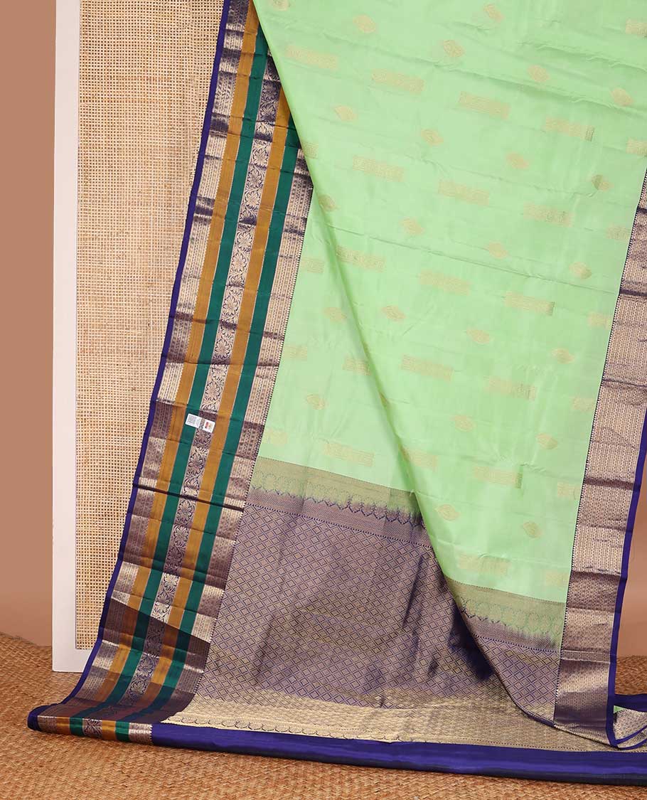 Green zari buttas silk saree, contrast border of rekku, neli, lavangam, Muthu, and rudraksham designs, and jaal pallu