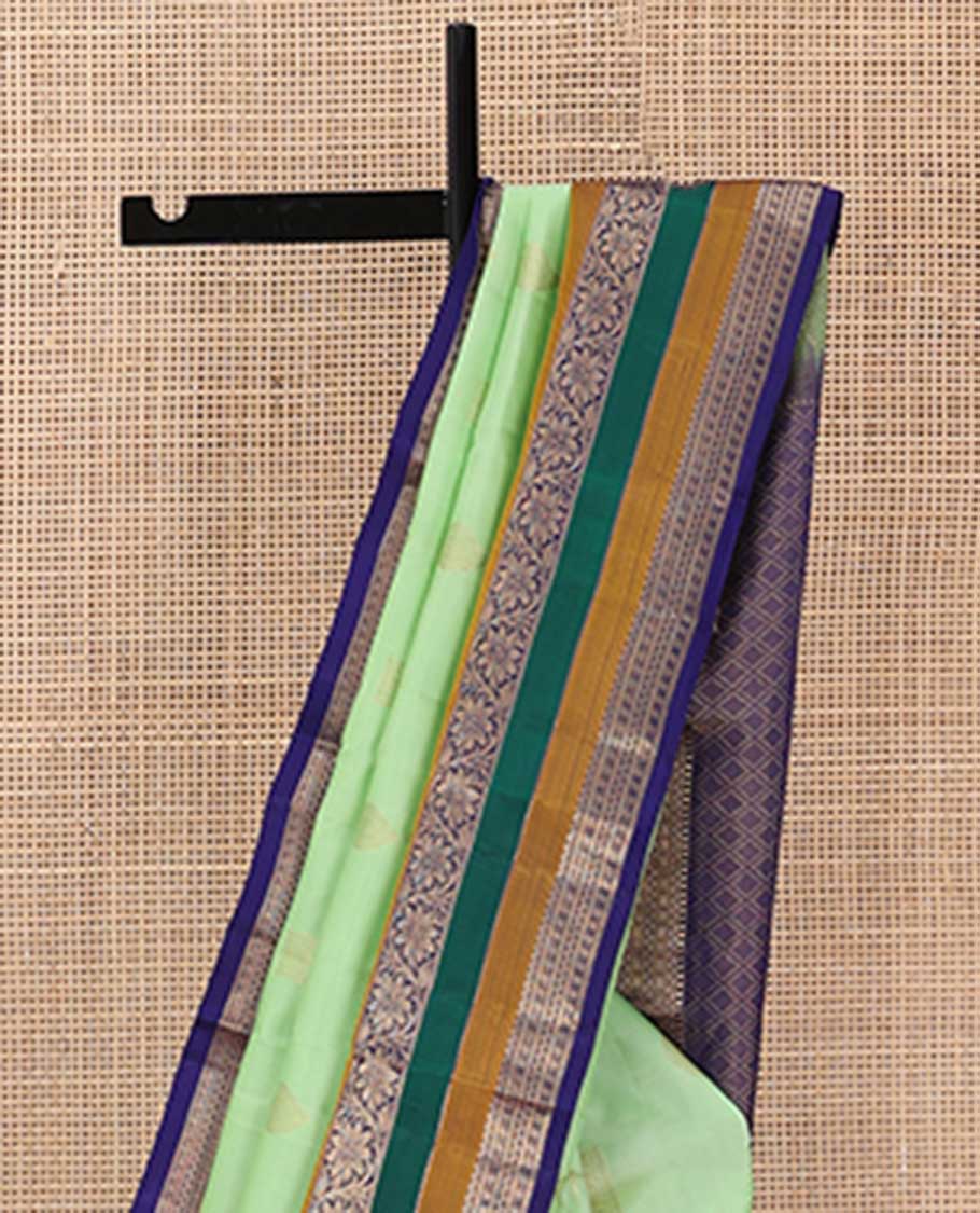 Green zari buttas silk saree, contrast border of rekku, neli, lavangam, Muthu, and rudraksham designs, and jaal pallu