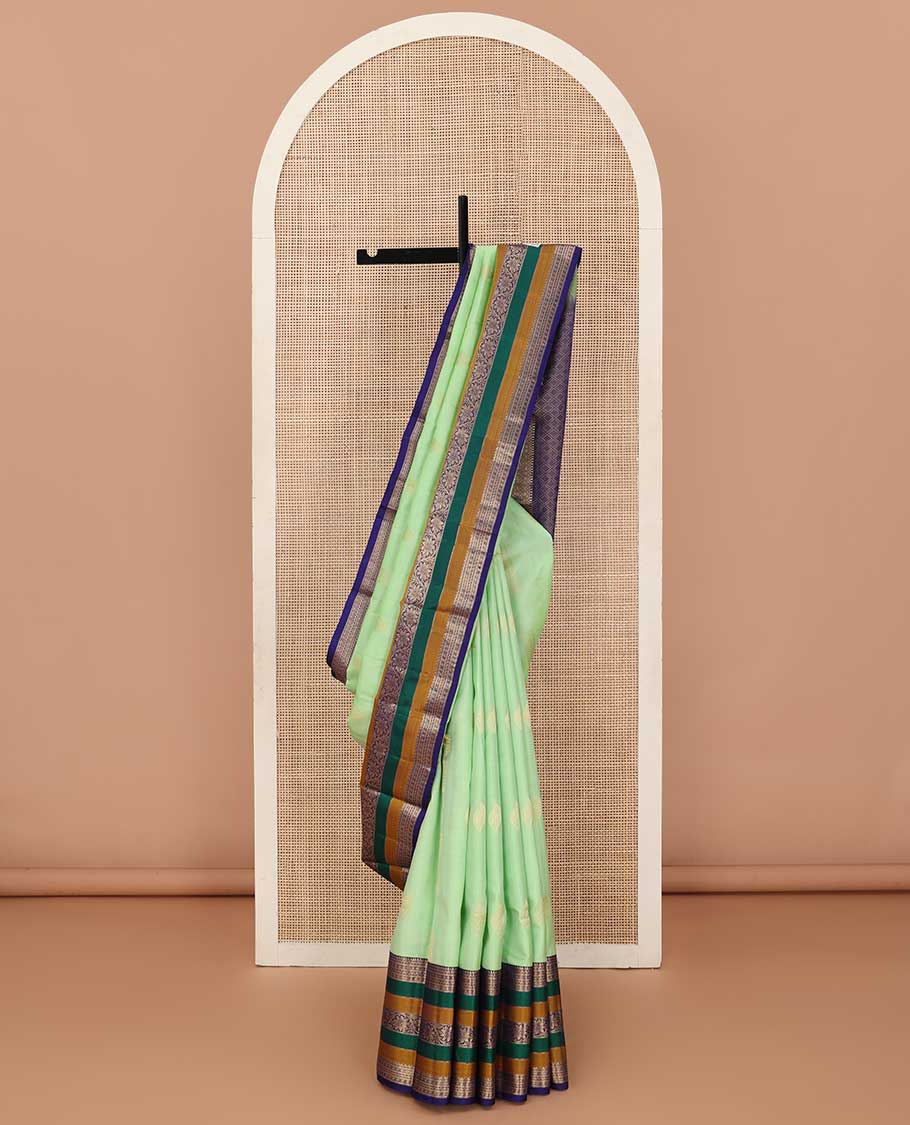 Green zari buttas silk saree, contrast border of rekku, neli, lavangam, Muthu, and rudraksham designs, and jaal pallu