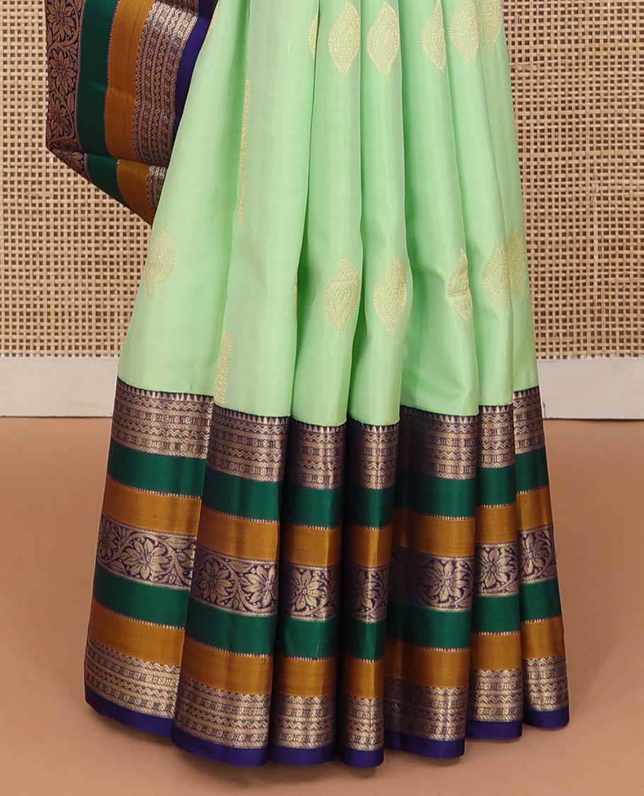 Green zari buttas silk saree, contrast border of rekku, neli, lavangam, Muthu, and rudraksham designs, and jaal pallu