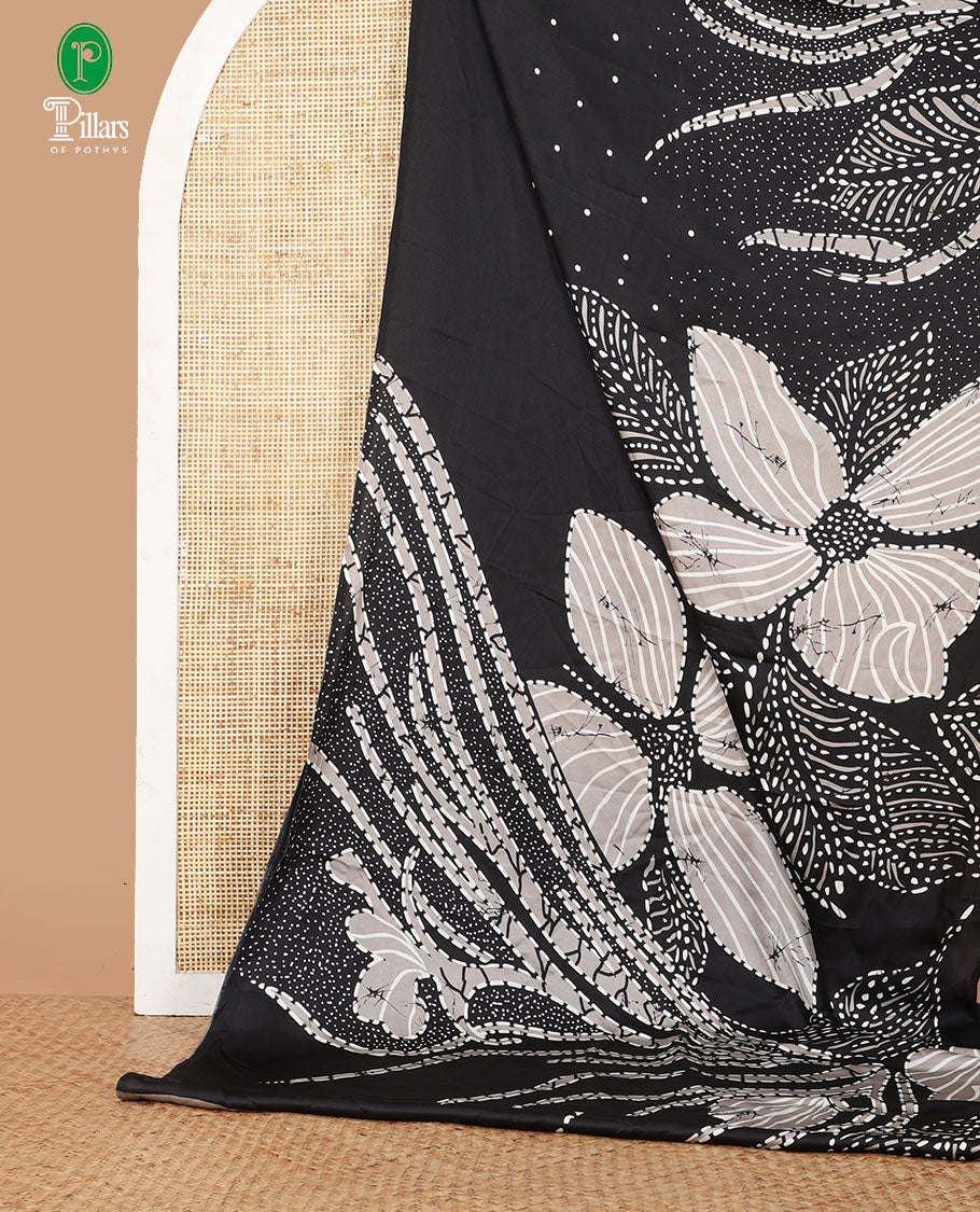 Borderless black half-and-half model satin saree with batik-style big floral motifs digital printed body and pallu