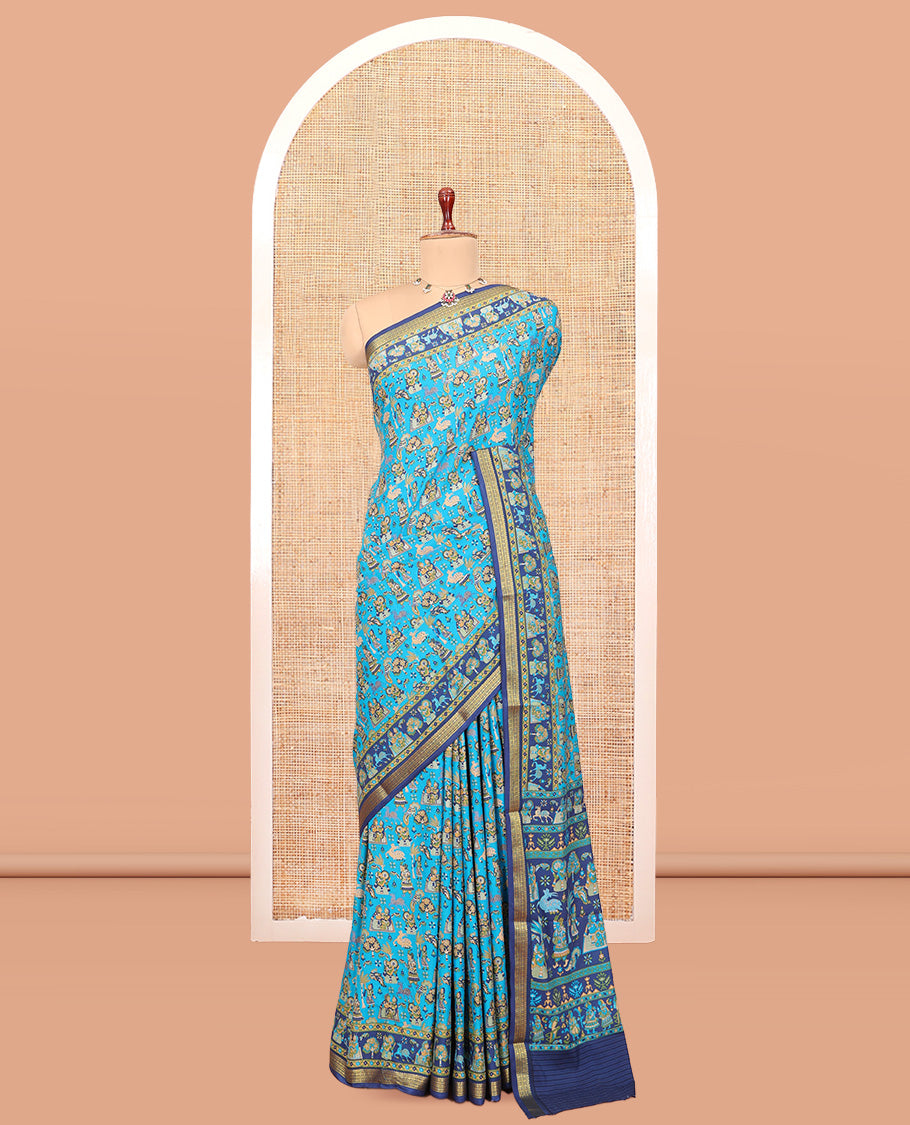 Blue Printed Silk Saree, Adorned with a Village-Themed Print, a Contrast Traditional Zari Border, Striped Pallu, and a Contrast Blouse