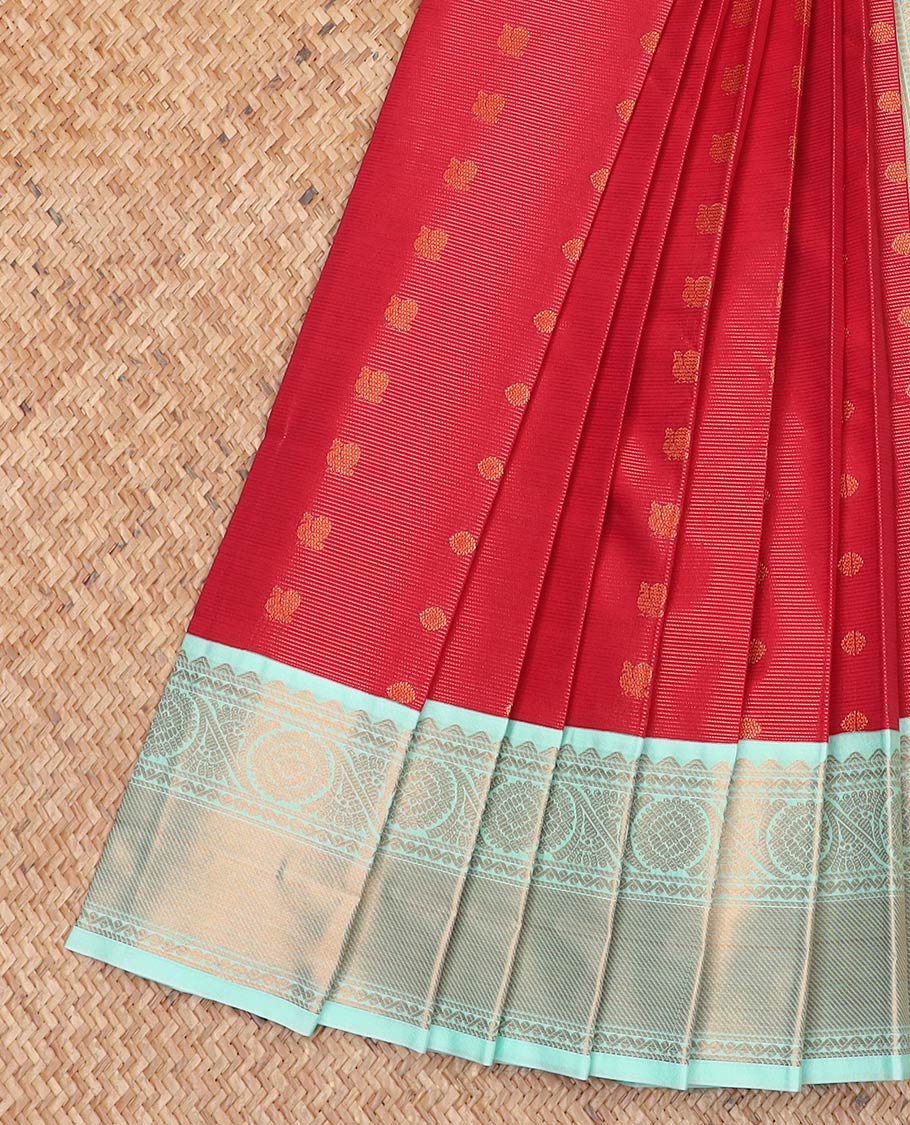 Red peacock chakram buttas and striped gift saree, contrast traditional zari border, and intricate pallu