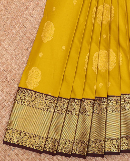 Yellow Budget Silk Saree, Subtly Sparkled with Paisley Buttas  All Over Its Body, Complemented by a Contrast Traditional Zari Design Border of Peacock Designs, Opulently Embellished Pallu, and Paired with a Contrast Blouse