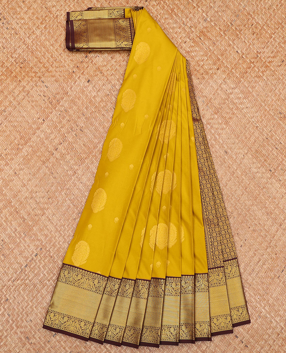 Yellow Budget Silk Saree, Subtly Sparkled with Paisley Buttas  All Over Its Body, Complemented by a Contrast Traditional Zari Design Border of Peacock Designs, Opulently Embellished Pallu, and Paired with a Contrast Blouse