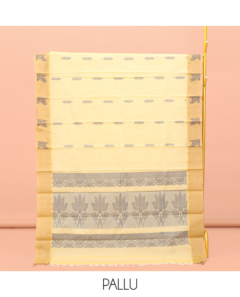 Yellow Kanchi Cotton Saree, Subtly Sparkled with Buttas All Over Its Body, Complemented by Contrast Border, Pallu of Floral Designs, and Paired with a Matching Blouse